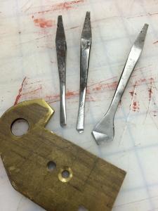 18th century metal cutting drill bits and countersink for a brace and the holes they formed in a brass plate